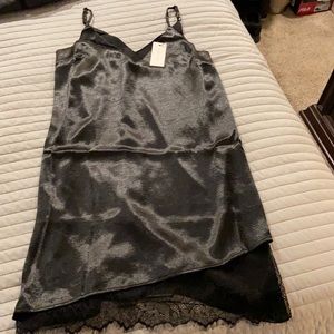 Black slip dress with asymmetrical lace hem